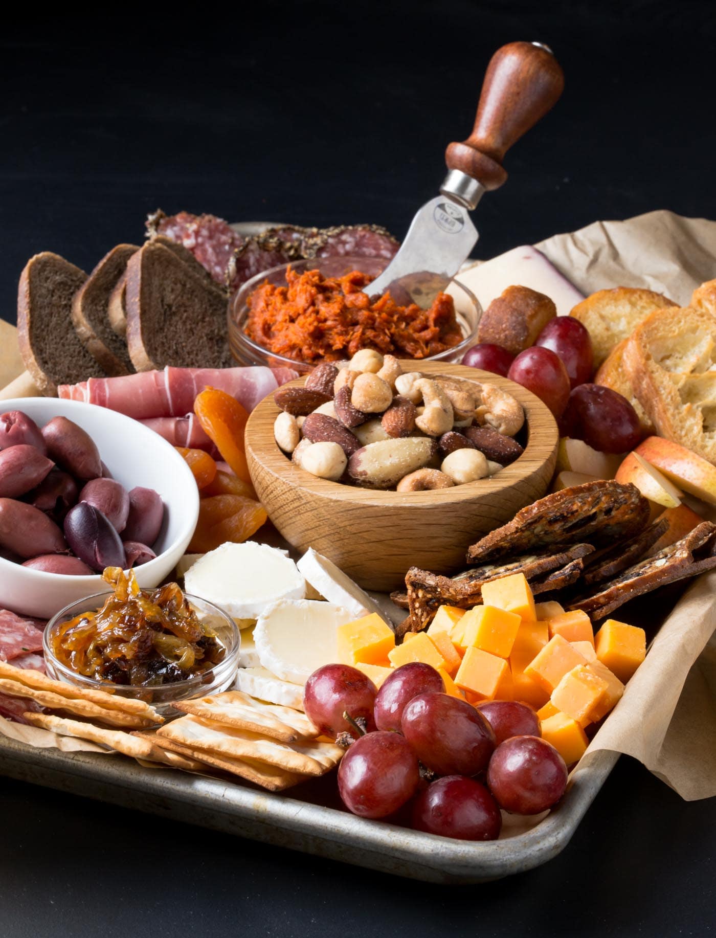 Close up of meat and cheese tray with nuts.