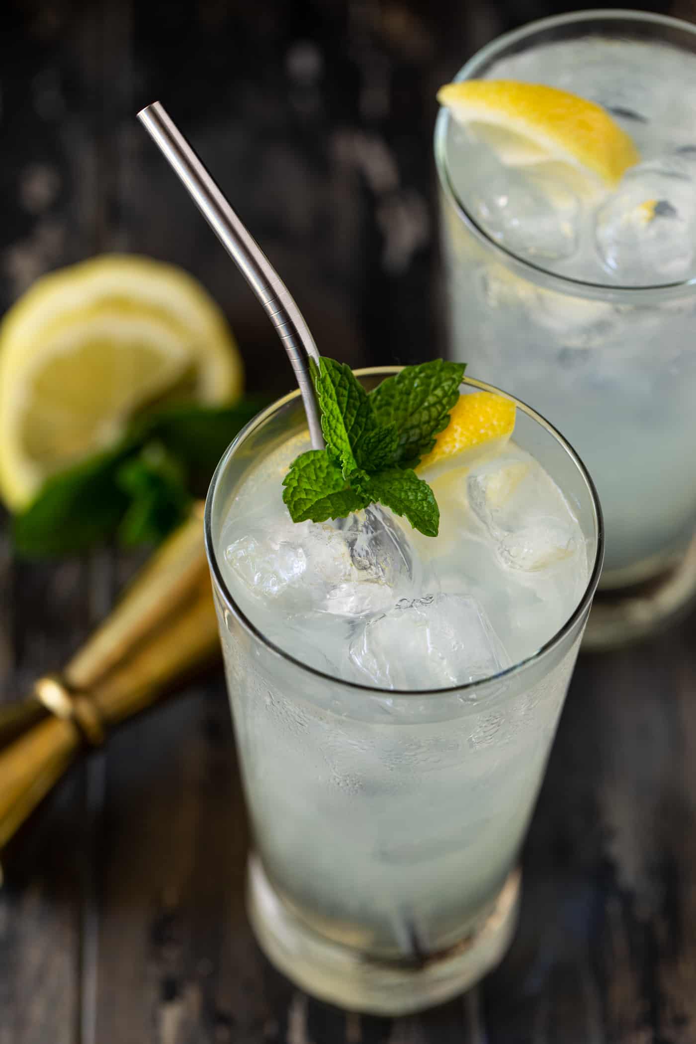 A glass of vodka lemonade with lemons.